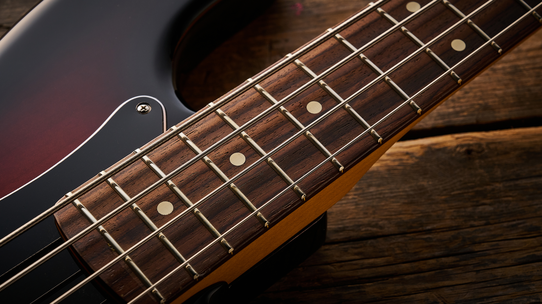 Fender American Professional Classic Precision Bass in 3-Color Sunburst shot on wood floor boards