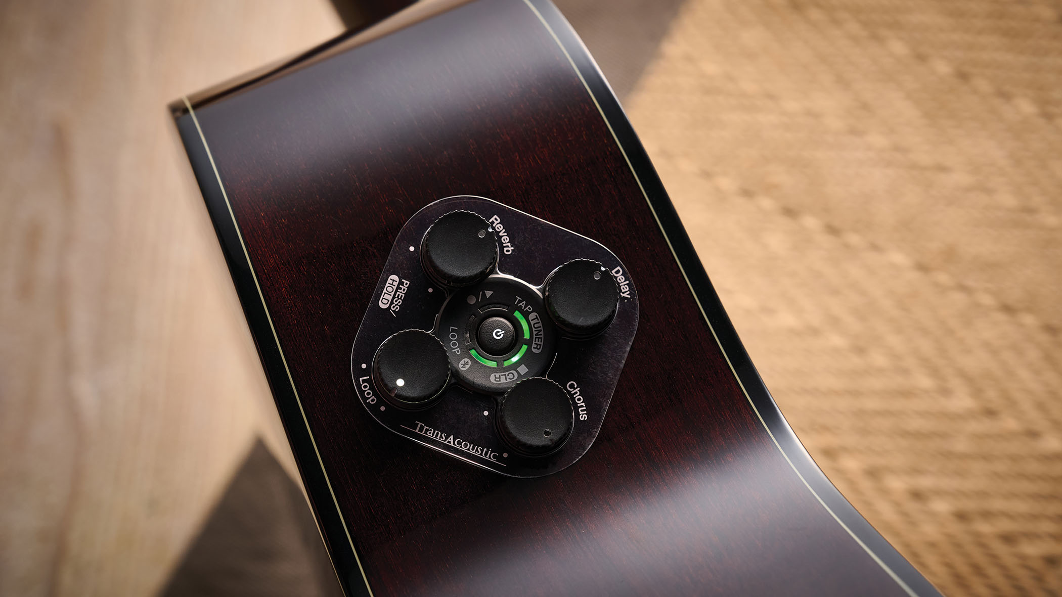 The Yamaha TransAcoustic TAG3 C is a cutaway acoustic guitar with a sandburst finished, photographed in closeup