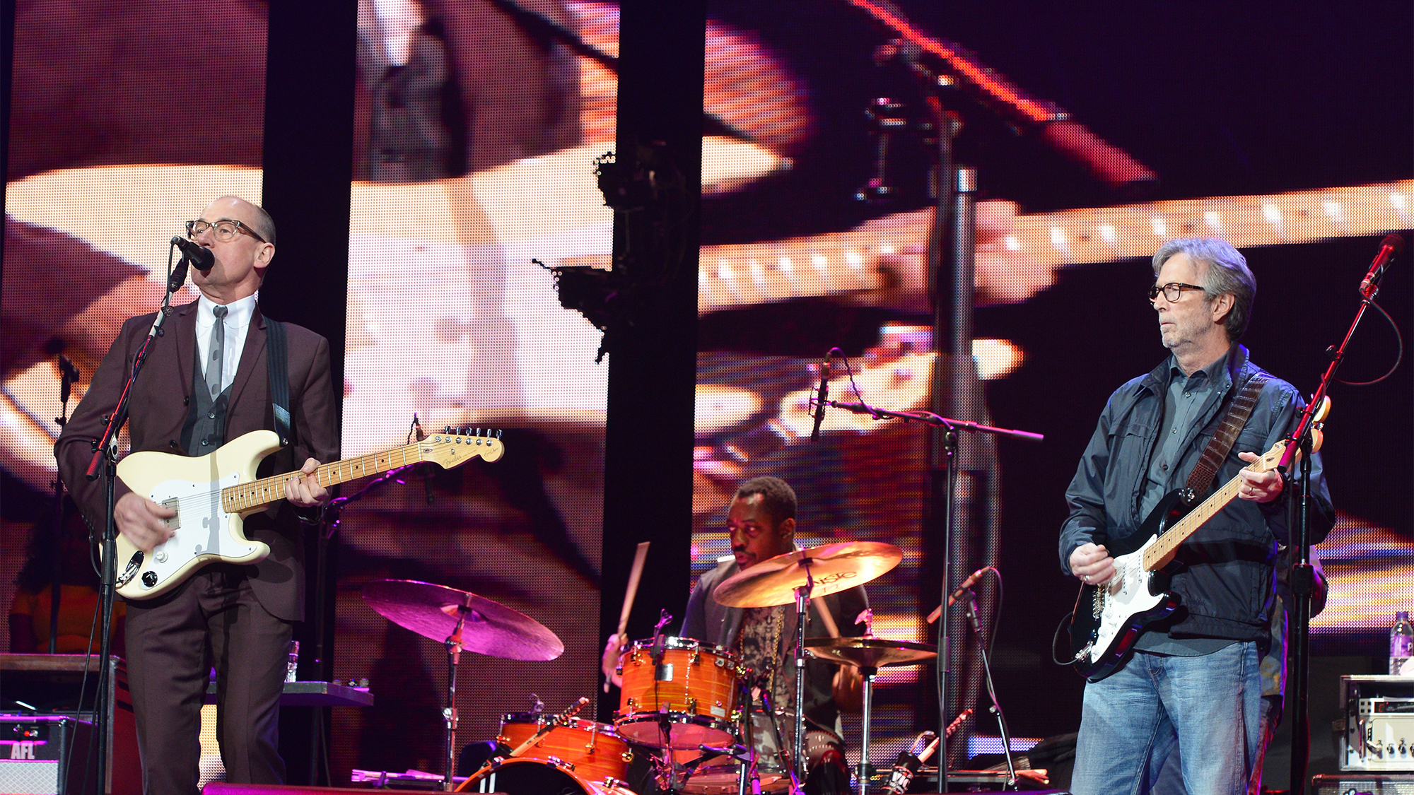 Andy Fairweather Low (L) and Eric Clapton perform on stage during the 2013 Crossroads Guitar Festival at Madison Square Garden on April 13, 2013 in New York City.