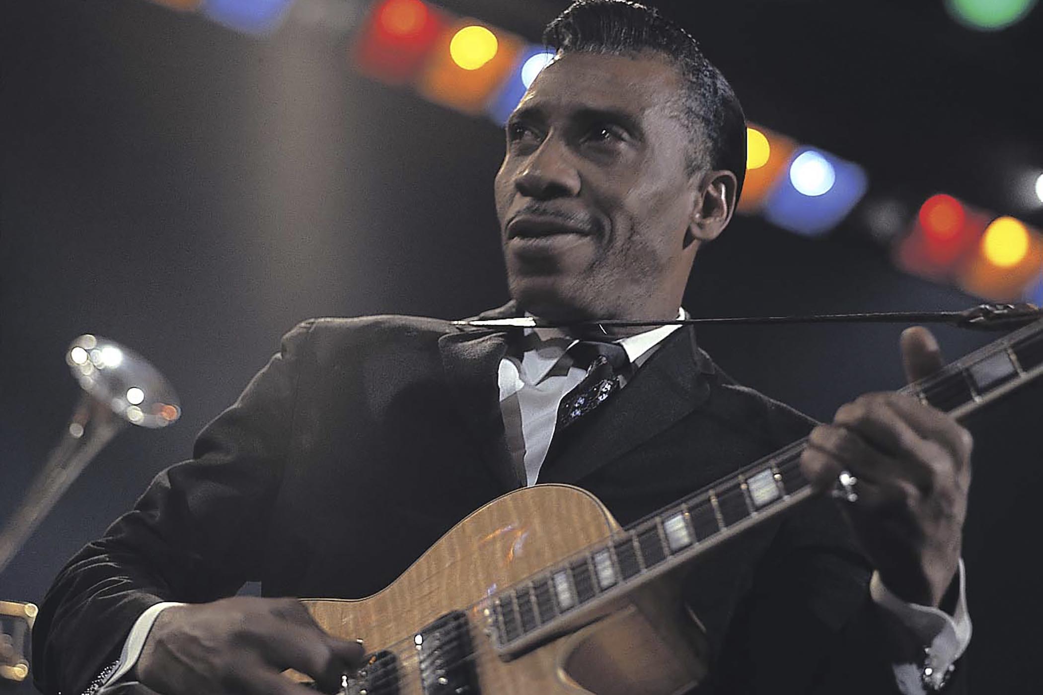 An color-shot of T-Bone Walker during his iconic Jazz At The Philharmonic performance, playing with his big-bodied Gibson electric