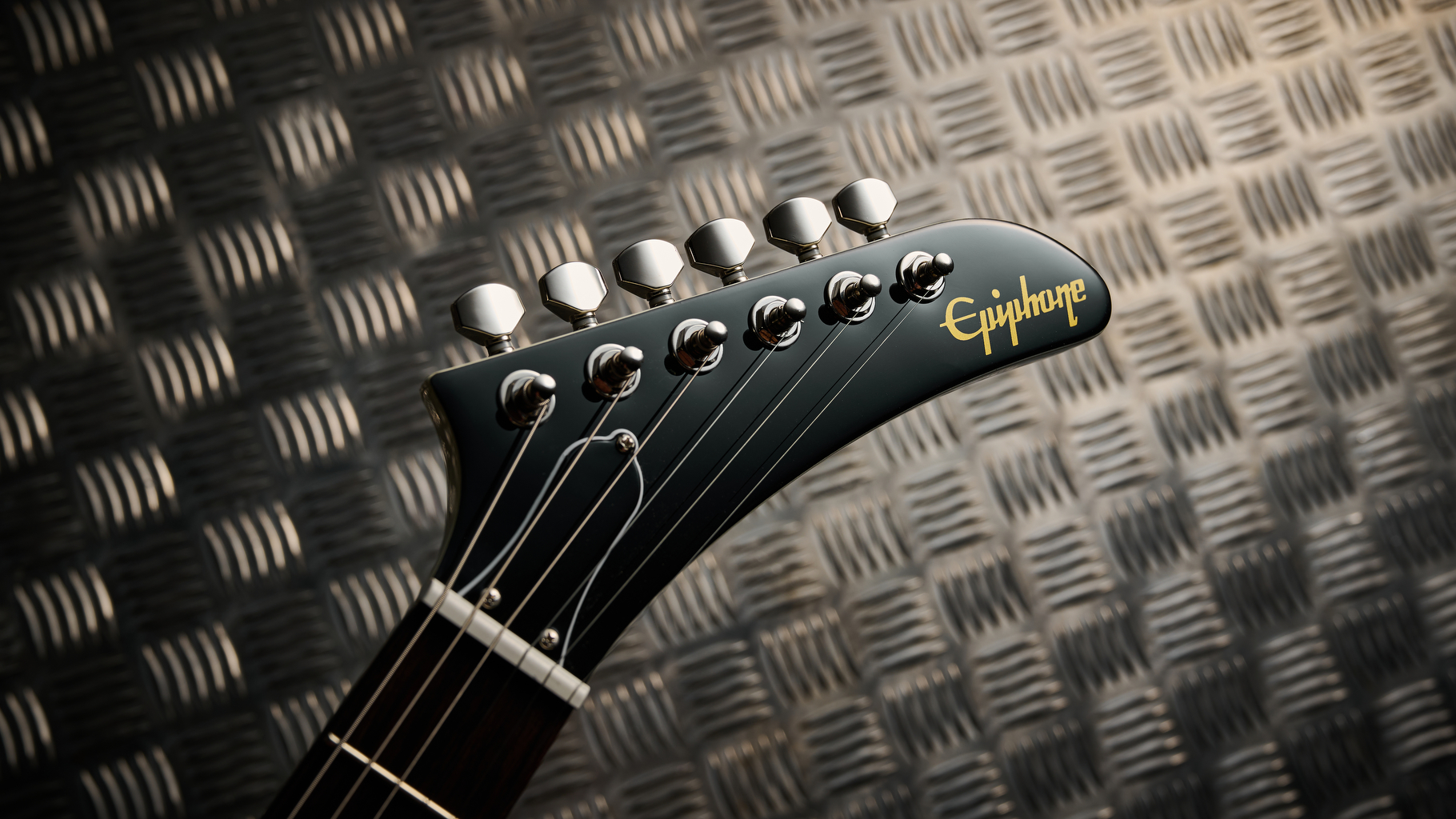 The headstock of the Epiphone Explorer 80s EMG electric guitar