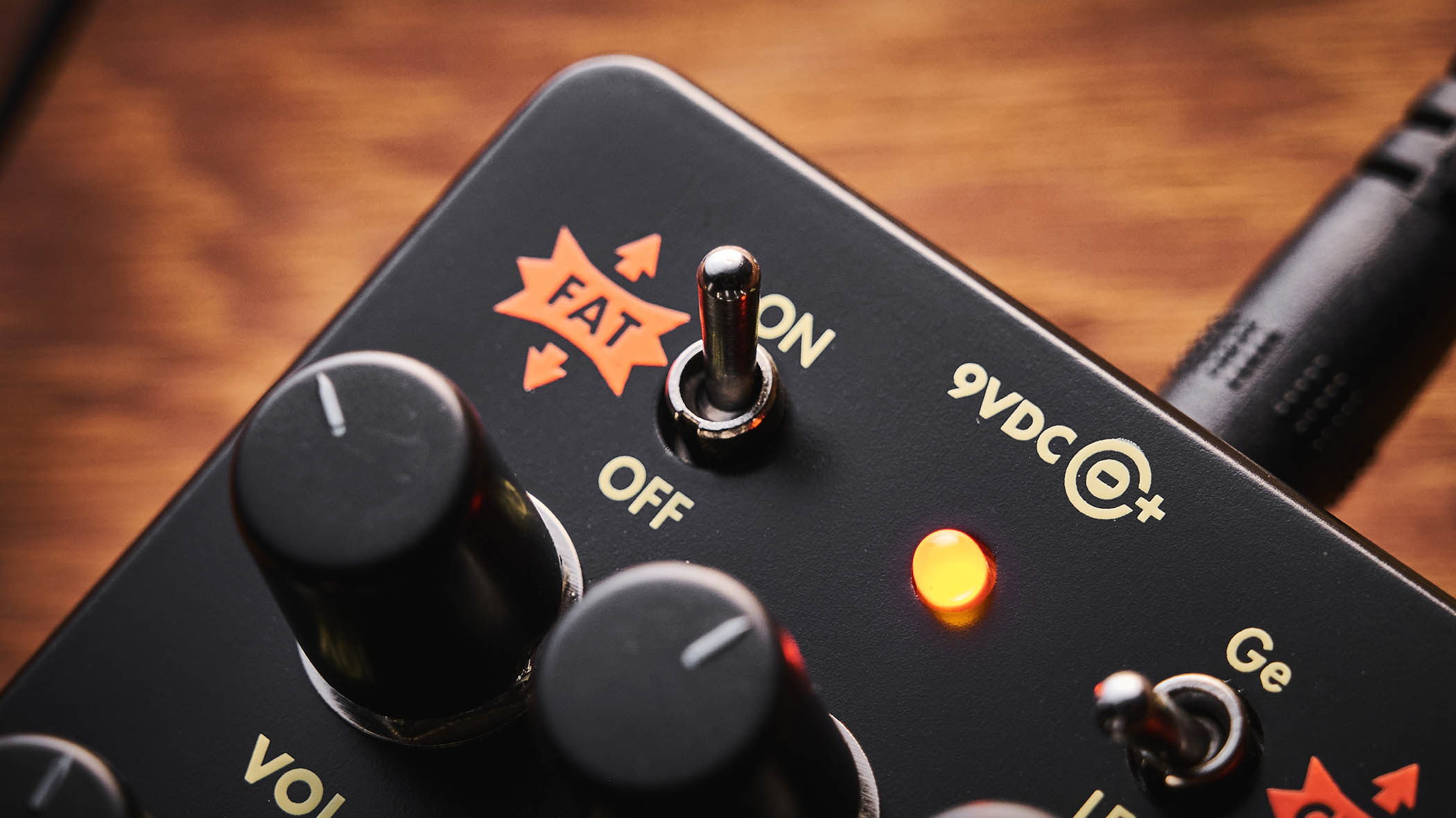 Electro-Harmonix Bender Royale &ndash; the feature-packed fuzz pedal is finished in a black enclosure with orange graphics/text, and is photographed here in warm tones against a wooden background.