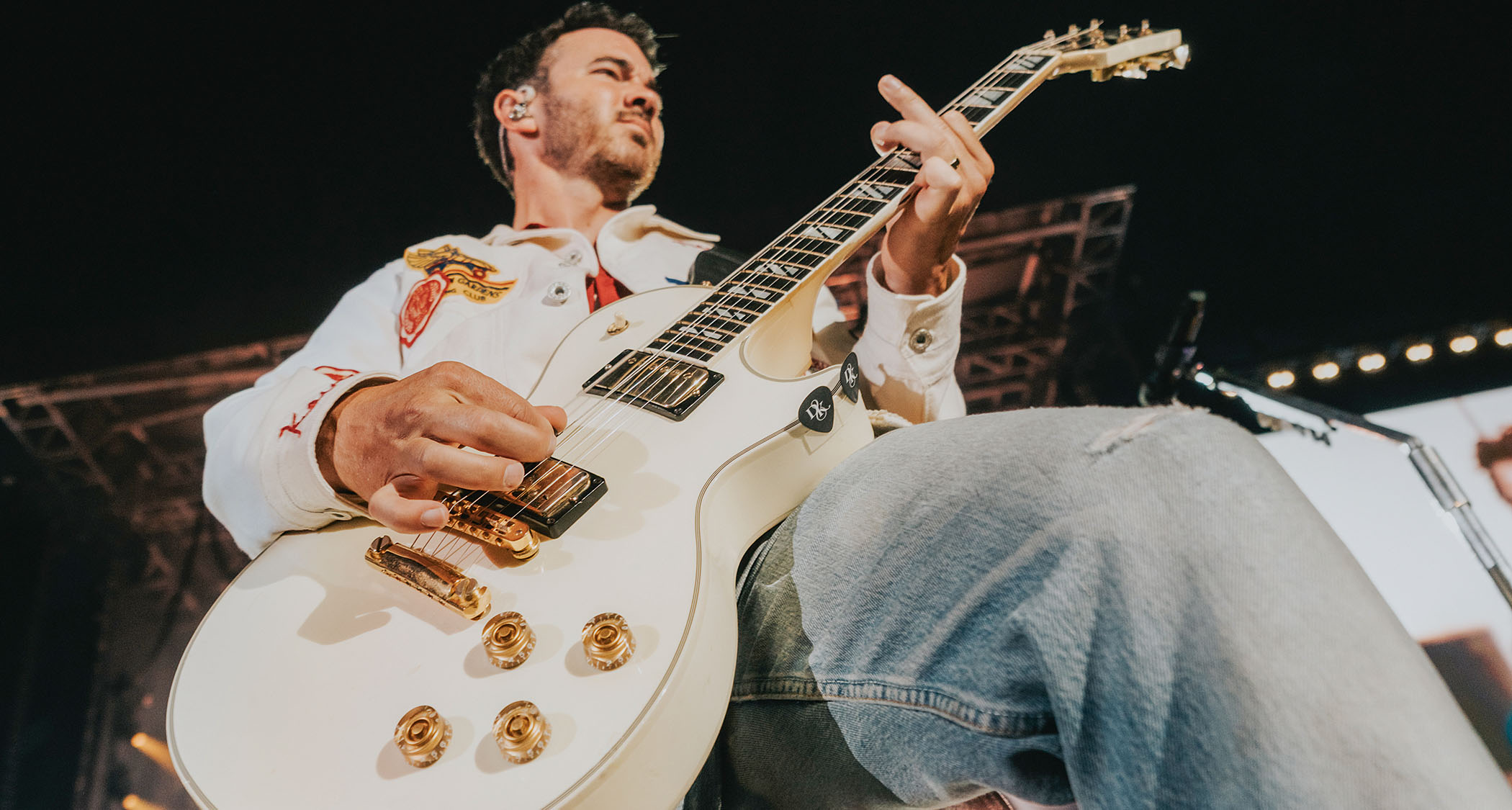 Kevin Jonas of the Jonas Brothers performs live with a white Les Paul
