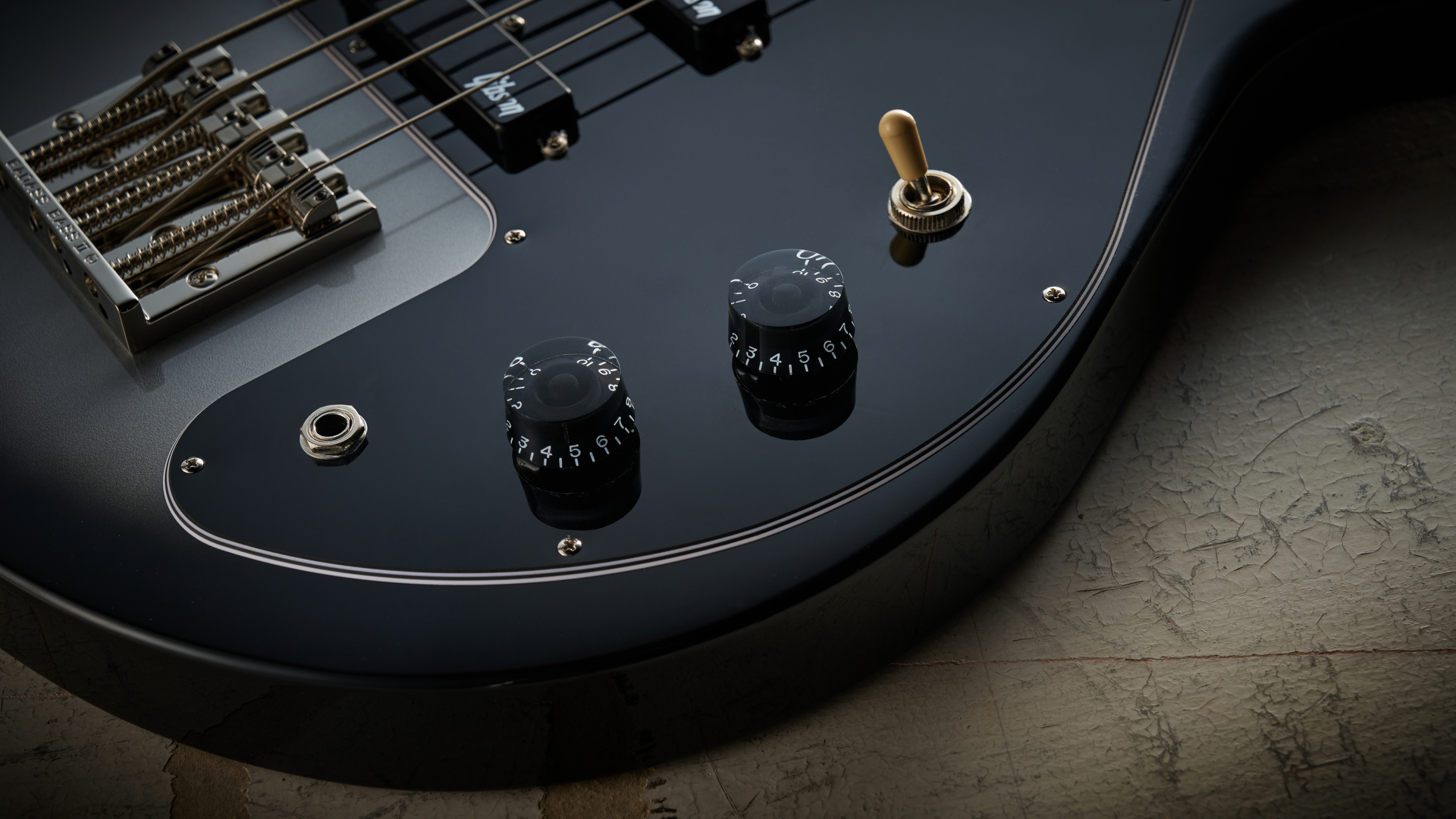 Epiphone Mike Dirnt Grabber G-3 in Silverburst finish photographed on scratched white board.