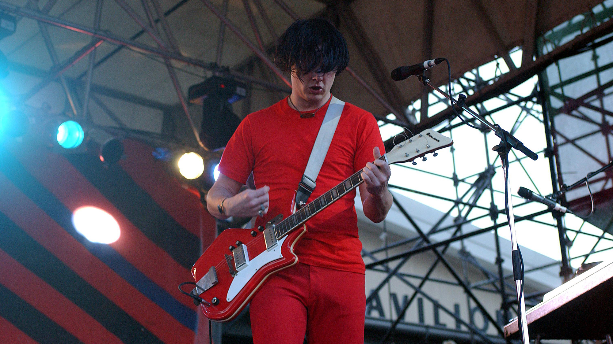 Jack White performing on stage, playing National Airline guitar