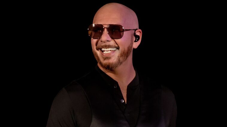 "Each time you wear that bald cap, you know an unforgettable experience is coming": Pitbull fans aim to set a world record at Hyde Park concert in July.]