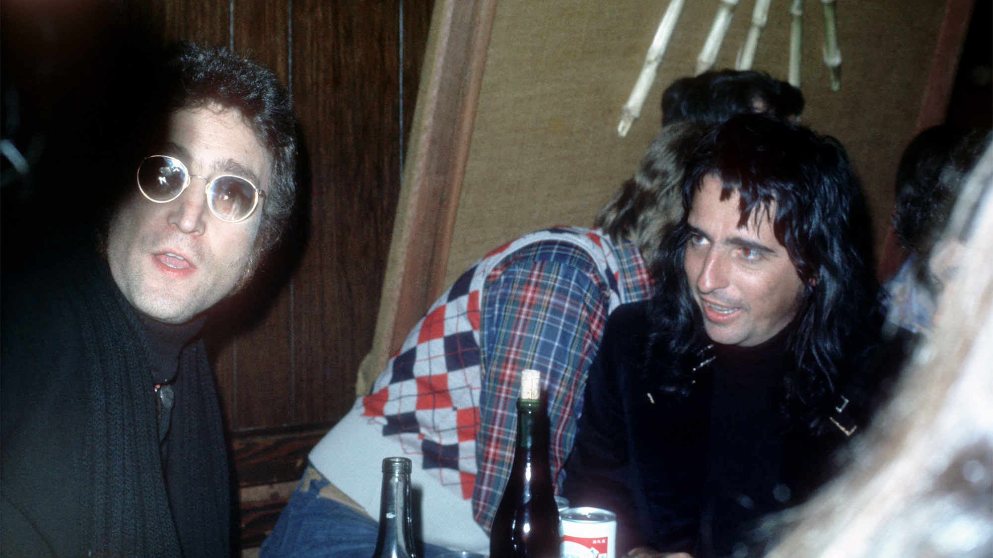 Drinking buddies known as 'The Hollywood Vampires' (L-R - John Lennon (during his 'Lost Weekend' period), Harry Nilsson and Alice Cooper celebrate an early Thanksgiving watching singer Anne Murray at the Troubadour on November 21, 1973 in Los Angeles, California.