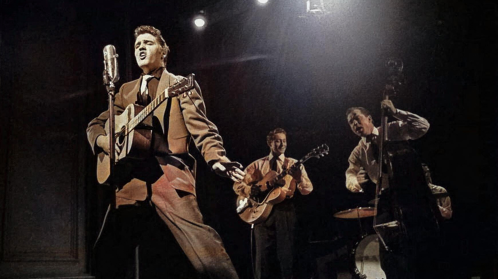 Elvis Presley on stage with Scotty Moore and Bill Black, 1956.