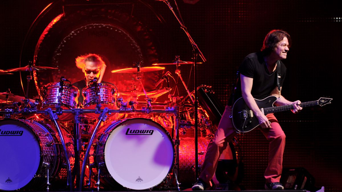 Musicians Alex Van Halen (L) and Eddie Van Halen of Van Halen perform at their dress rehearsal for family and friends at the Forum on February 8, 2012 in Inglewood, California