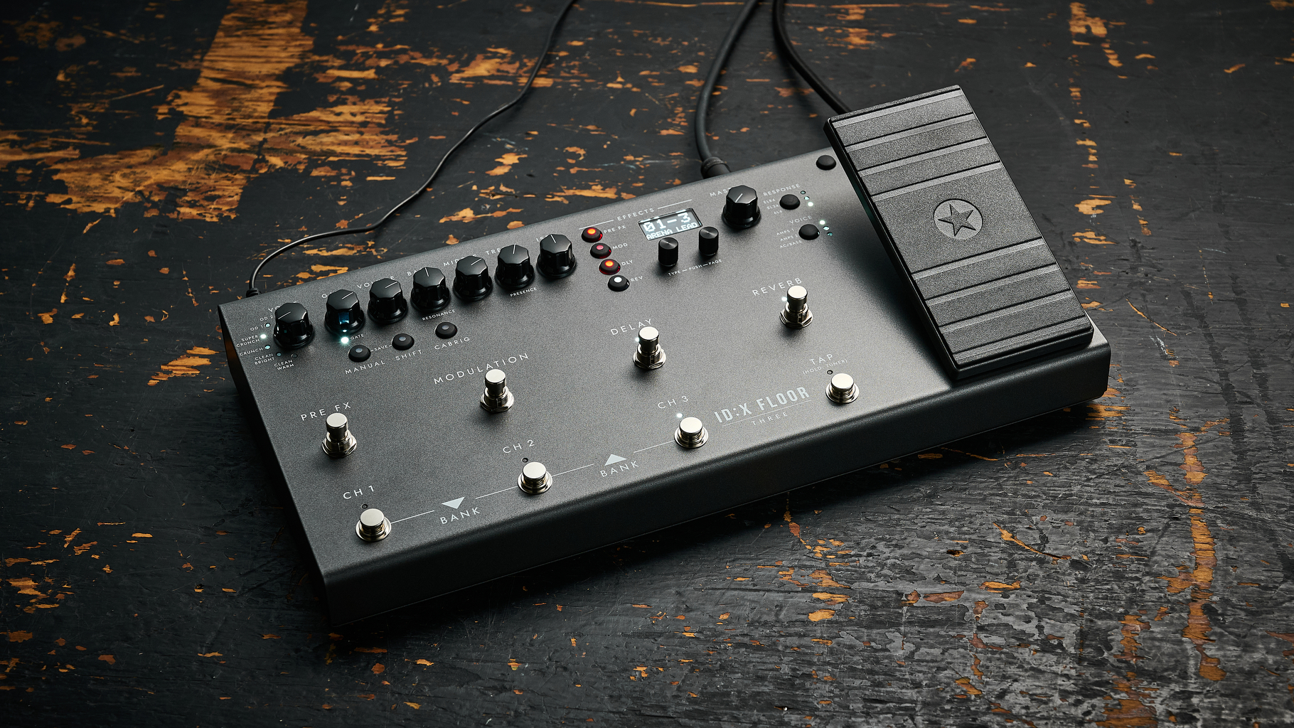 A Blackstar ID:X Floor Three multi-effects pedal and amp modeller on a worn, wooden floor