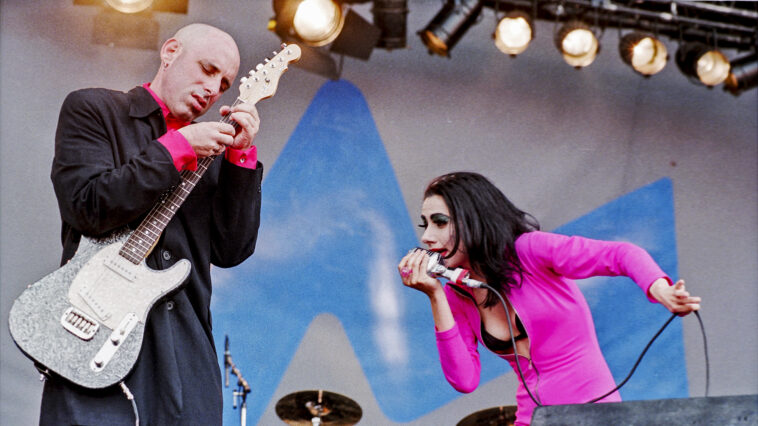 P.J. Harvey on why she stopped playing guitar onstage — and the real reason she chose her first pair of tour guitarists: “So I can look at their behinds.”