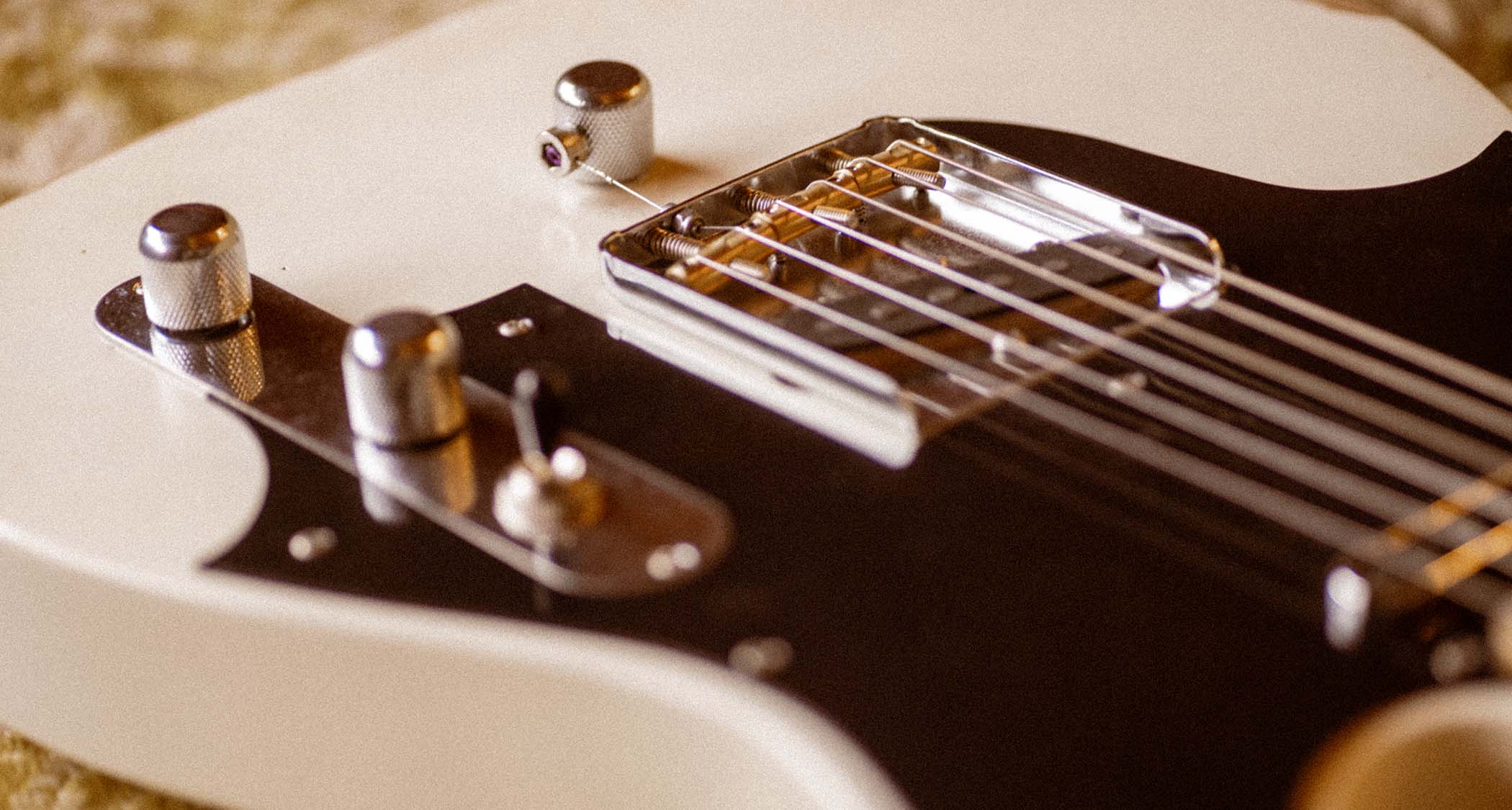 The Fender John Osborne Telecaster comes factory modded with a B-Bender and has an extended black pickguard on a Road Worn Olympic White body.