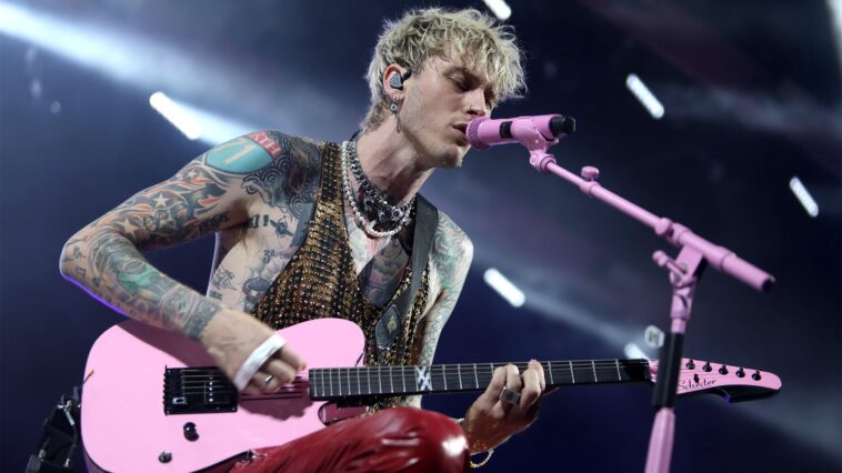 Machine Gun Kelly halts concert following fan's fall through the stage.]