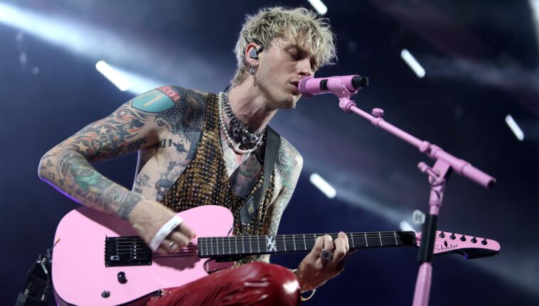 Machine Gun Kelly halts concert following fan's fall through the stage.]