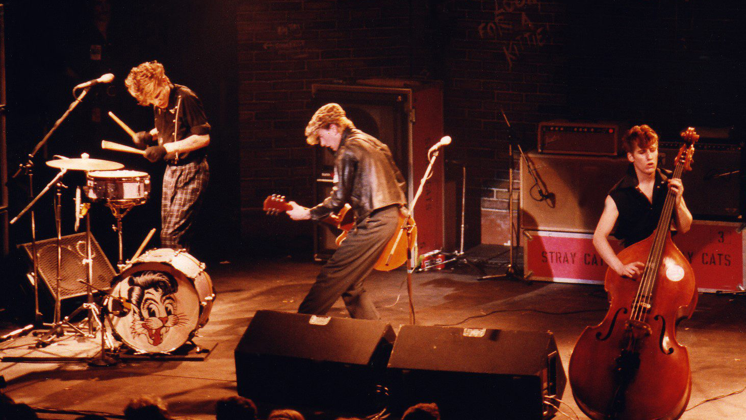 Slim Jim Phantom, Brian Setzer and Lee Rocker of The Stray Cats perform on stage at the Lyceum Theatre in the Strand, on March 23rd, 1981 in London, England.