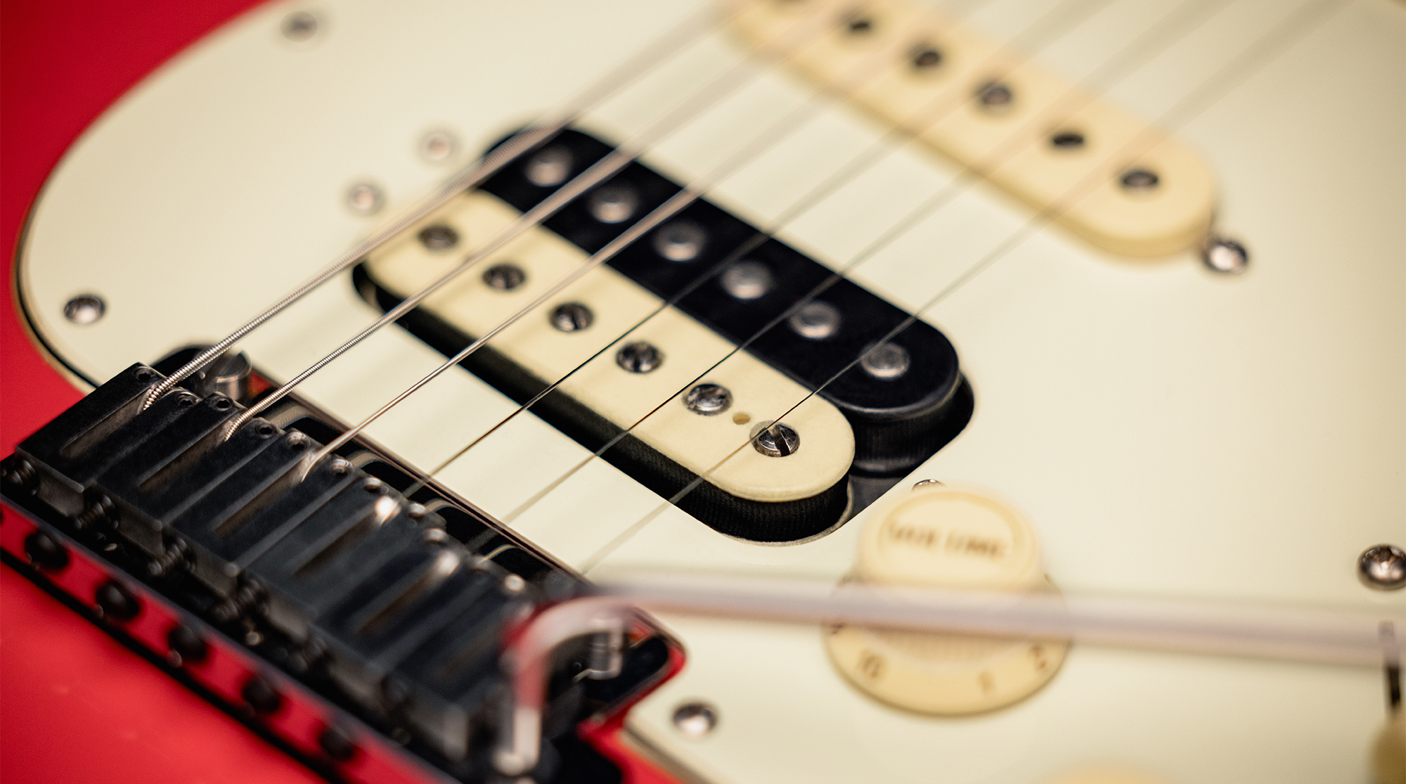 A detail photo of the Fender American Ultra Luxe Vintage &rsquo;60s Stratocaster HSS in Fiesta Red