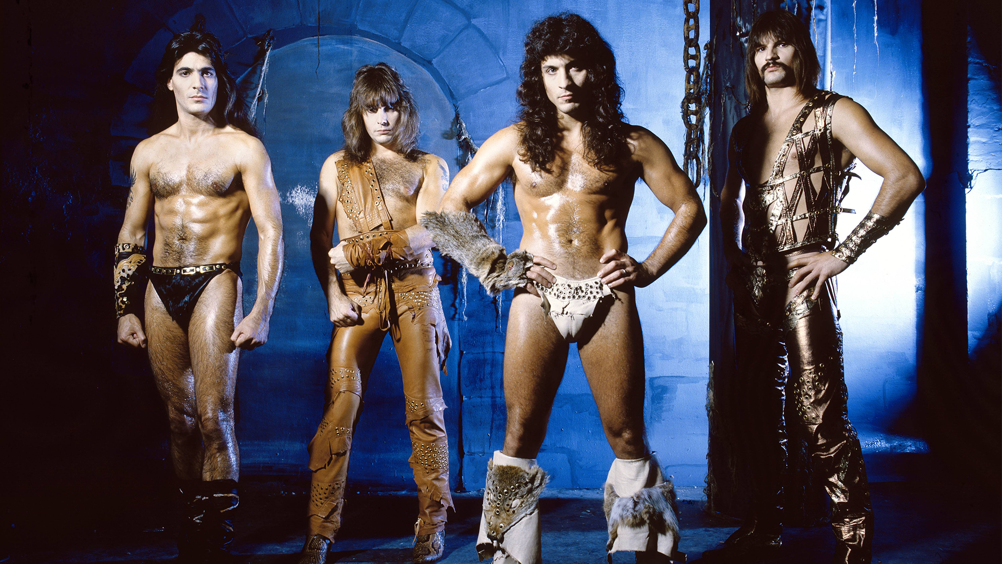 Photo of Joey DeMAIO and Ross FRIEDMAN and Scott COLUMBUS and MANOWAR and Eric ADAMS; Posed studio group portrait, full length, barechested L-R Joey DeMaio, Ross the Boss, Eric Adams and Scott Columbus