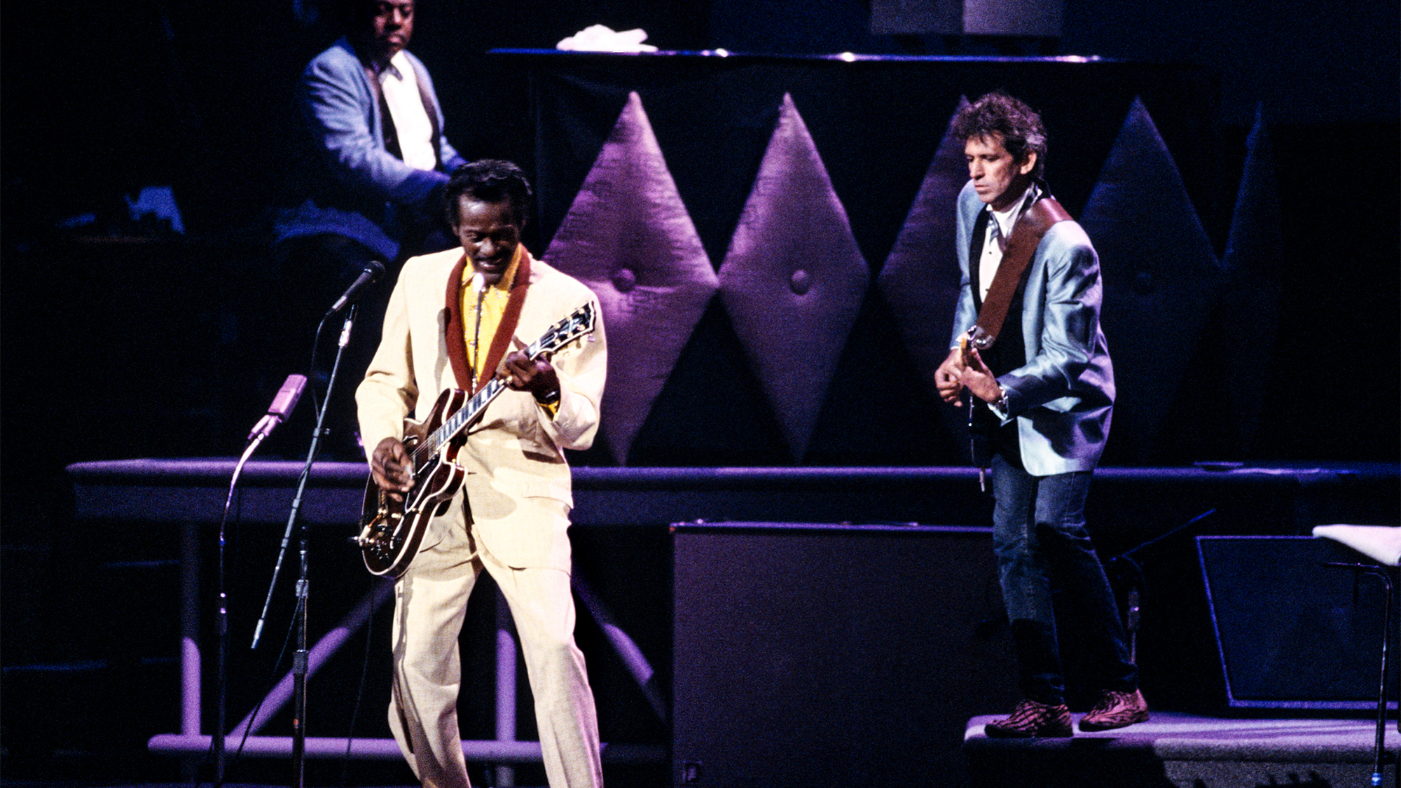 Chuck BERRY and Keith RICHARDS and Johnnie JOHNSON; Johnnie Johnson, Chuck Berry and Keith Richards performing on stage at Chuck's 60th Birthday Concert for the filming of "Hail Hail Rock &amp; Roll"