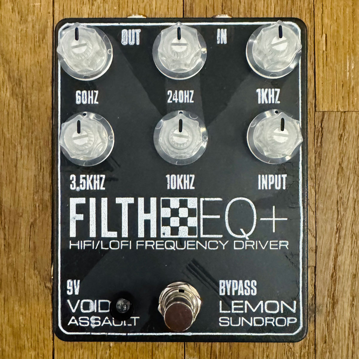 The Filth EQ+ Hifi/Lofi Frequency Driver pedal, pictured on a wood floor