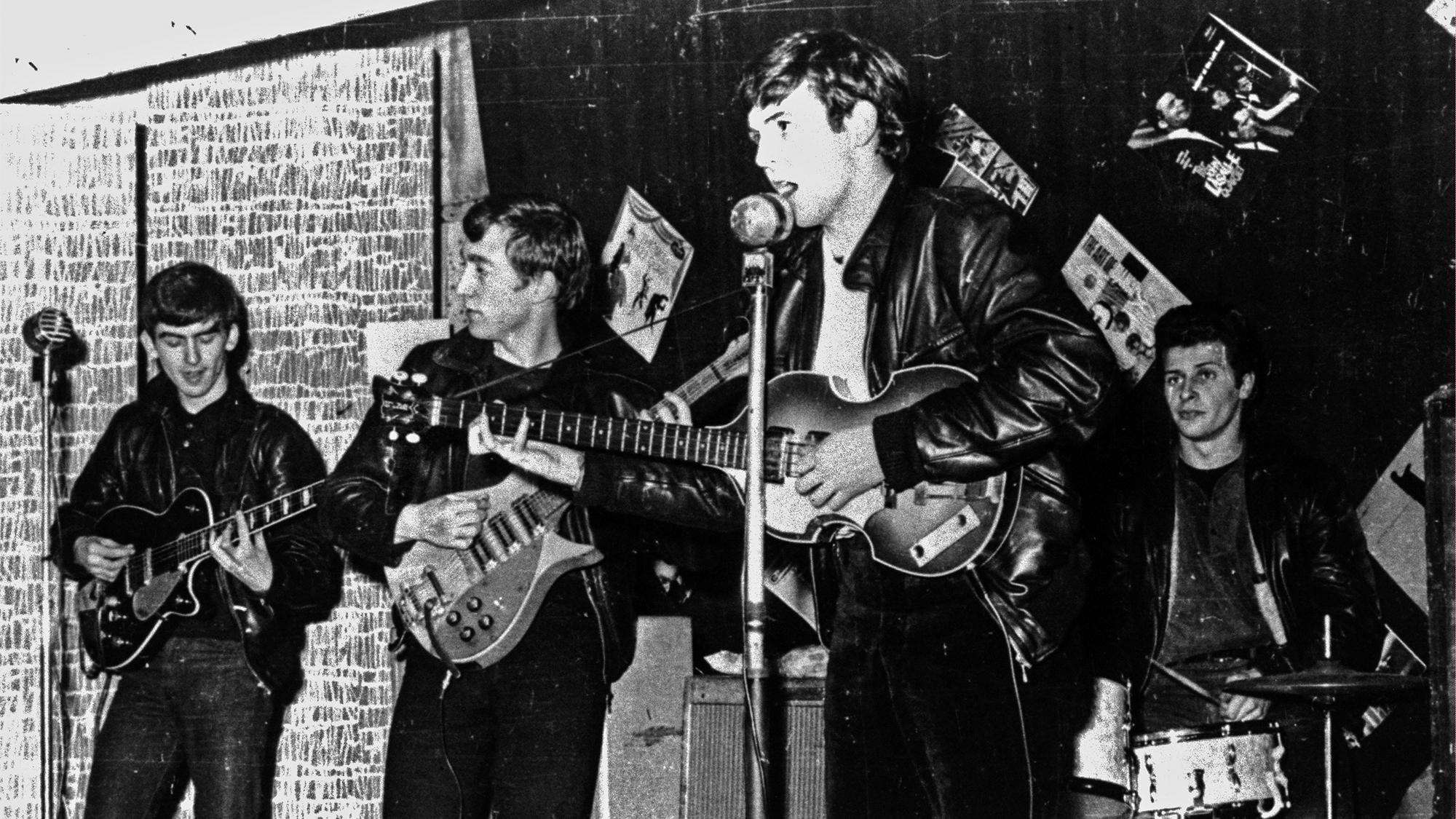 British rock group The Beatles perform in a club prior to signing their first recording contract, Liverpool, England, 1962. L-R: George Harrison, John Lennon, Paul McCartney, and original drummer Pete Best.