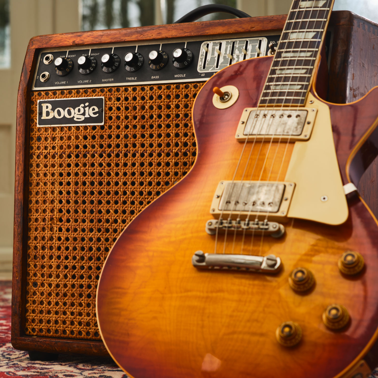 A Gibson Les Paul leans on a vintage MESA/Boogie combo amp