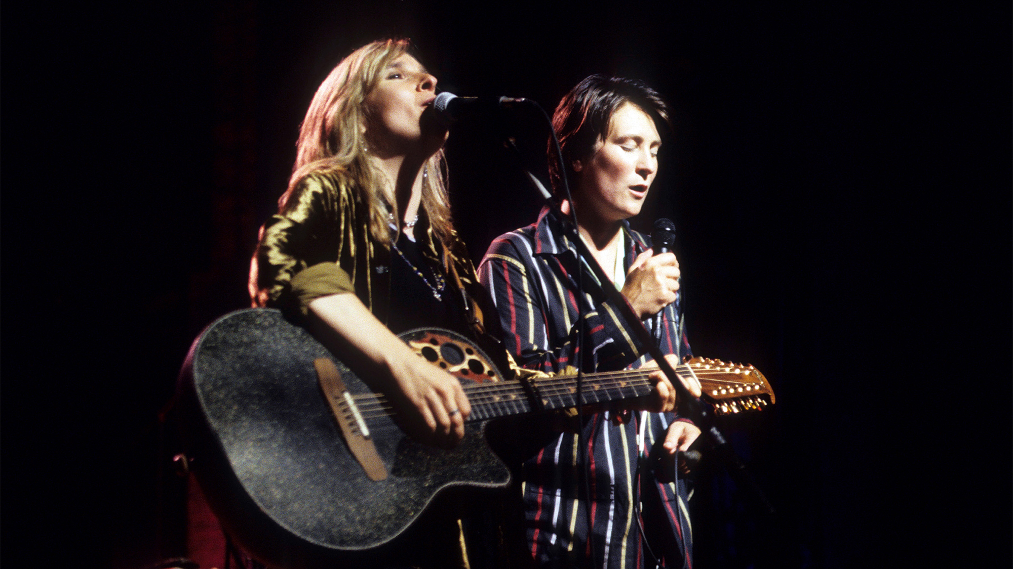 American Folk &amp; Rock musician Melissa Etheridge (left), on acoustic guitar, and Canadian Country &amp; Pop musician kd lang (born Katheryn Dawn Lang) perform, during Lifebeat's 'The Beat Goes On' benefit concert, onstage at the Beacon Theatre, New York, New York, June 24, 1994.