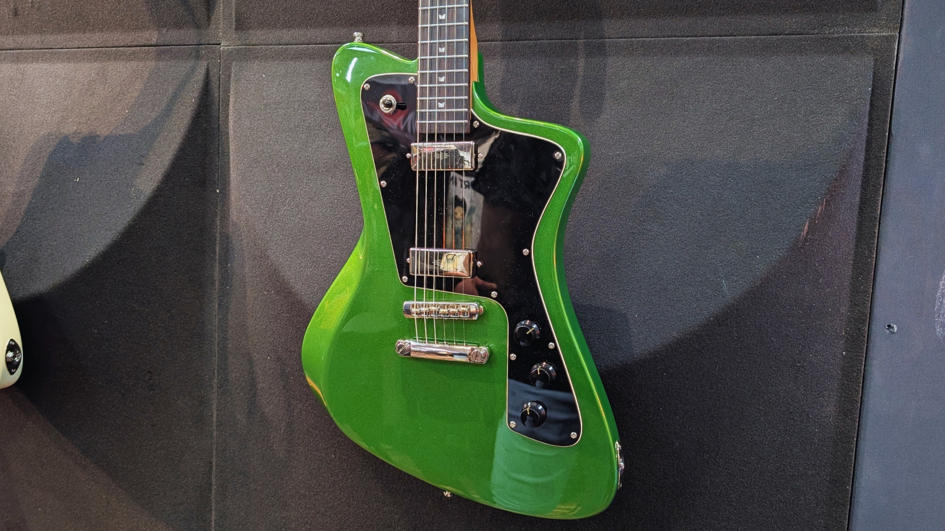 A Baum Wingman 2026 electric guitar on the wall at The Guitar Show in Birmingham, UK