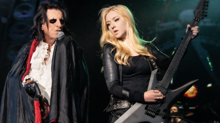 "Alice Cooper Introduces His New Guitarist, Gaining Nita Strauss's Endorsement: 'We’re Excited for the Wild Moments Ahead!'"]