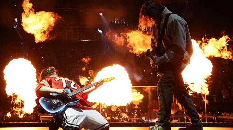 "Billie Eilish Reveals Why Her Brother Finneas Became a 'Rapunzel' Figure in Her Tour, Calling Her Latest Grammy Win for 'Wildflower' a 'Miracle' Amidst Rumors of a Falling-Out"]