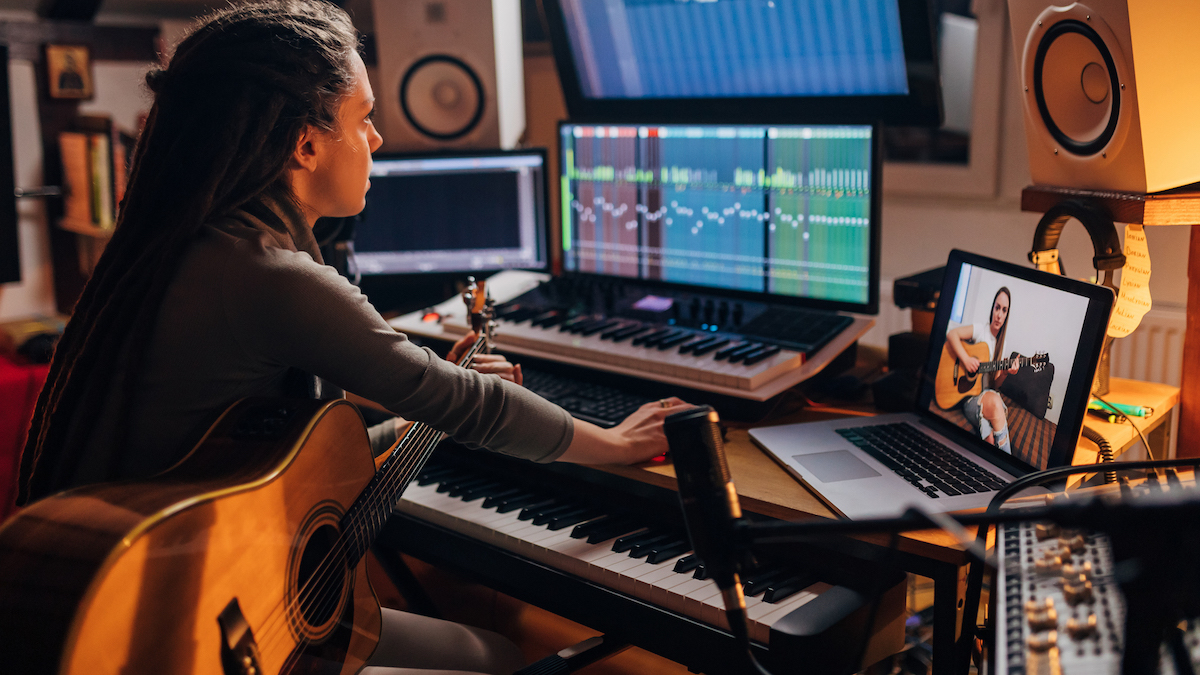 Woman recording acoustic guitar