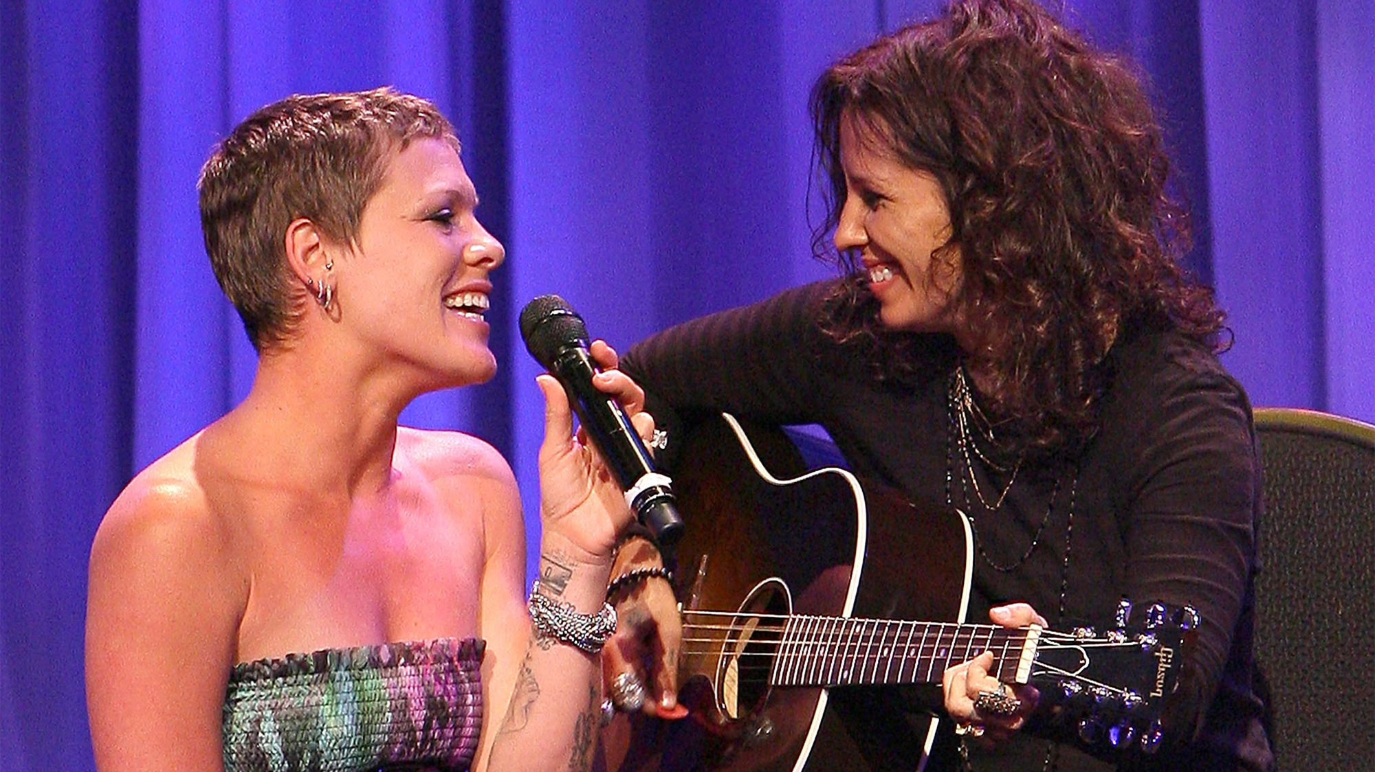 Singers Pink (L) and Linda Perry (R) perform at the L.A. Gay &amp; Lesbian Center's "An Evening With Women" on May 1, 2010 in Beverly Hills, California.
