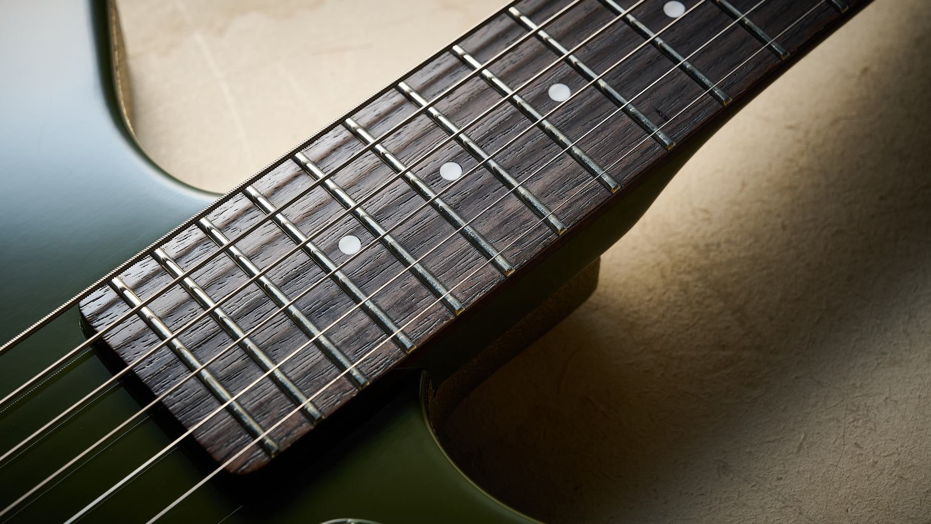 The rosewood fretboard of the Danelectro Dan O Cool Baritone guitar