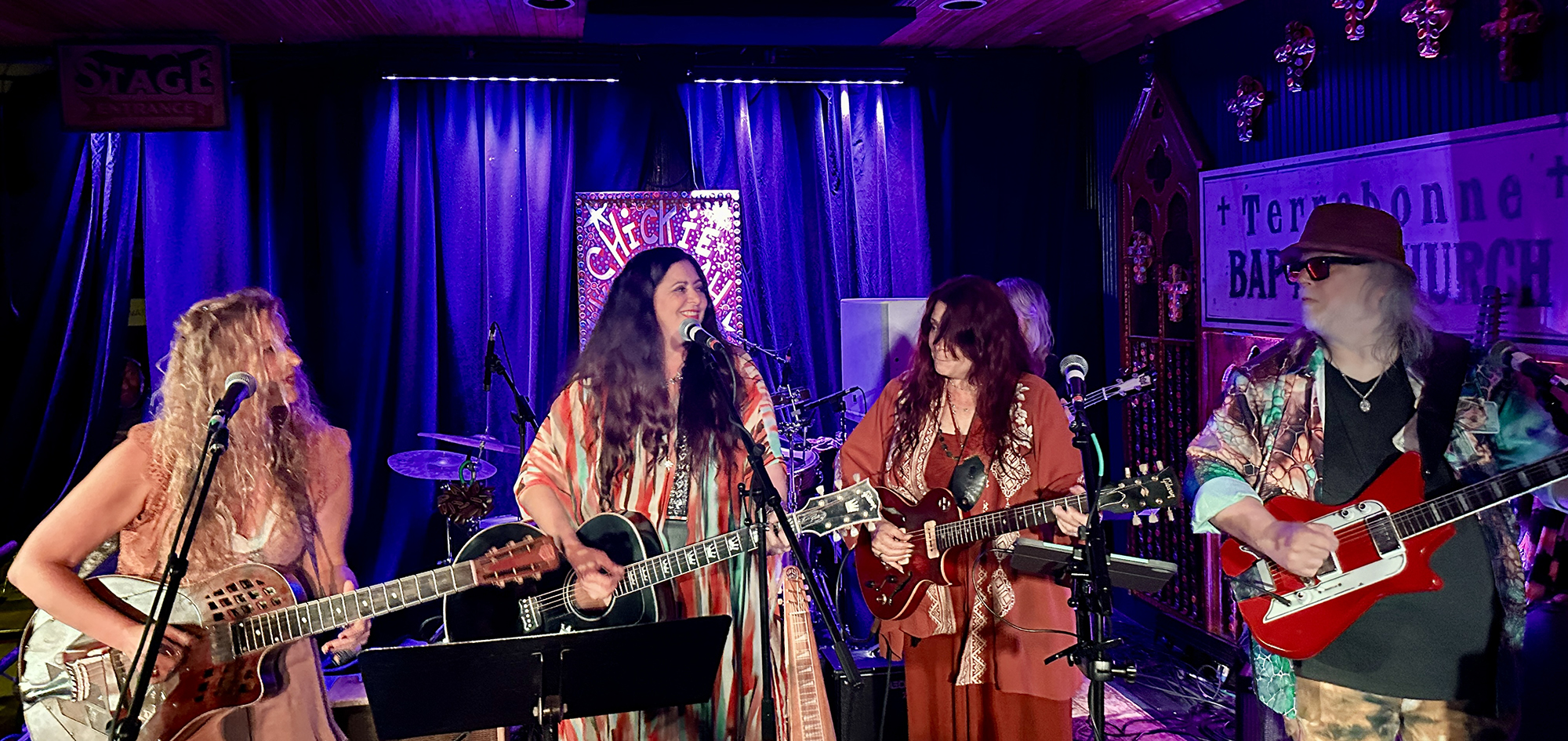 Musicians perform at the 2024 David Lindley tribute. (front, from left) Layla Musselwhite, Shelley King, Carolyn Wonderland and Papa Mali. (background) Cass Faulconer on bass, Wally Ingram on drums