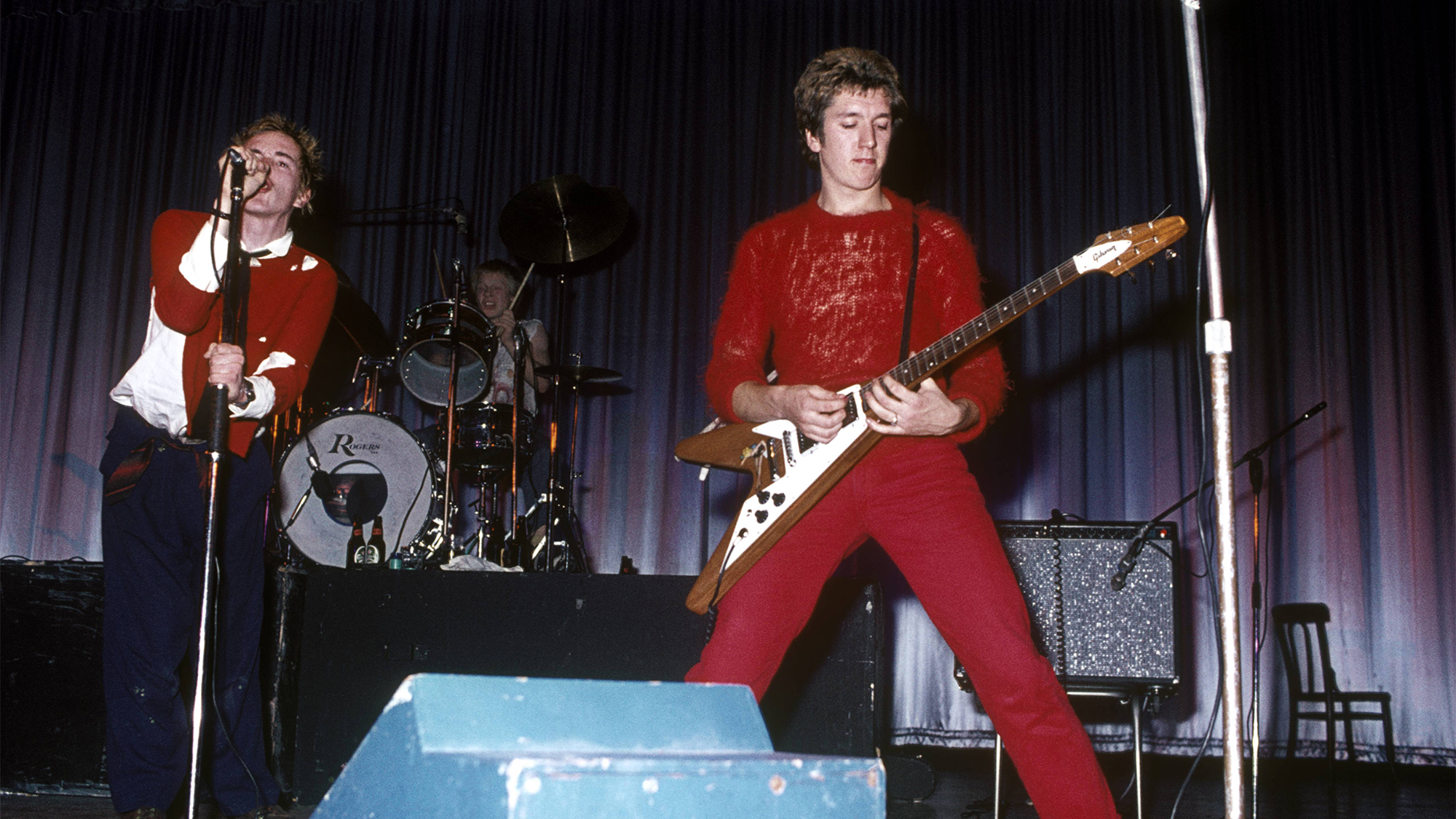 Photo of Steve JONES and Johnny ROTTEN and SEX PISTOLS; Johnny Rotten (John Lydon), Paul Cook &amp; Steve Jones performing live onstage at Dunstable's Queensway Hall