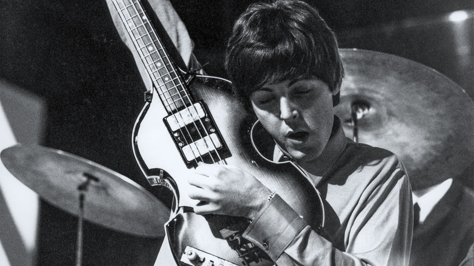 Paul McCartney of English rock and pop group The Beatles tunes up his Hofner 500/1 violin bass guitar on stage during rehearsals for the ABC Television music television show 'Thank Your Lucky Stars' Summer Spin at Teddington Studios in London on 11th July 1964. The band would go on to play four songs on the show, A Hard Day's Night, Long Tall Sally, Things We Said Today and You Can't Do That.