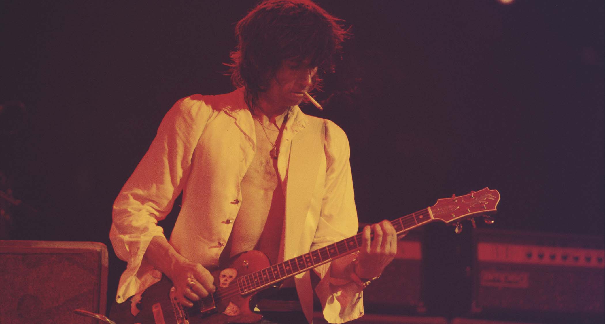 Keith Richards smokes a cigarette and plays his Zemaitis single-cut onstage in 1976.