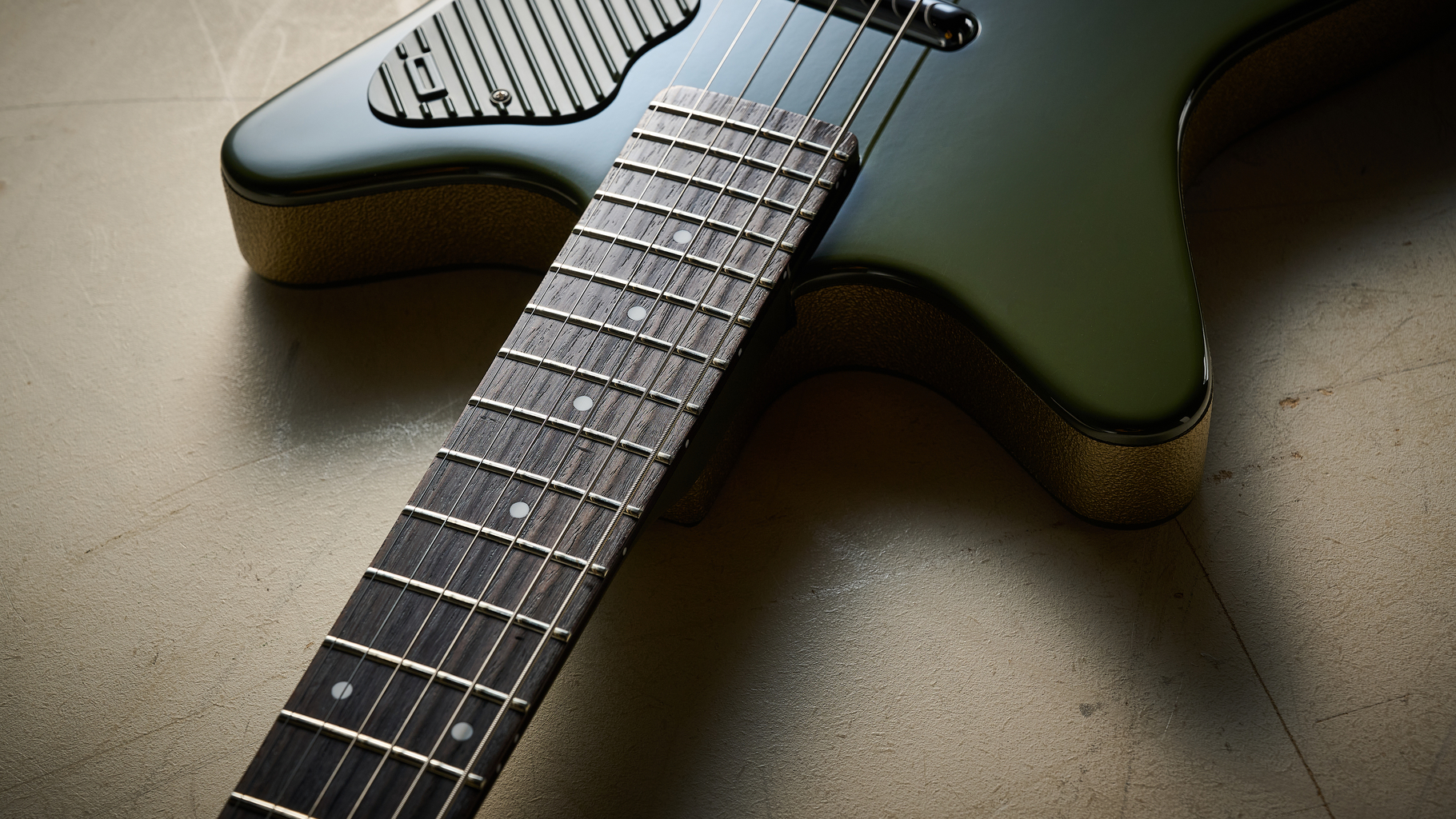 The rosewood fretboard of the Danelectro Dan O Cool Baritone guitar