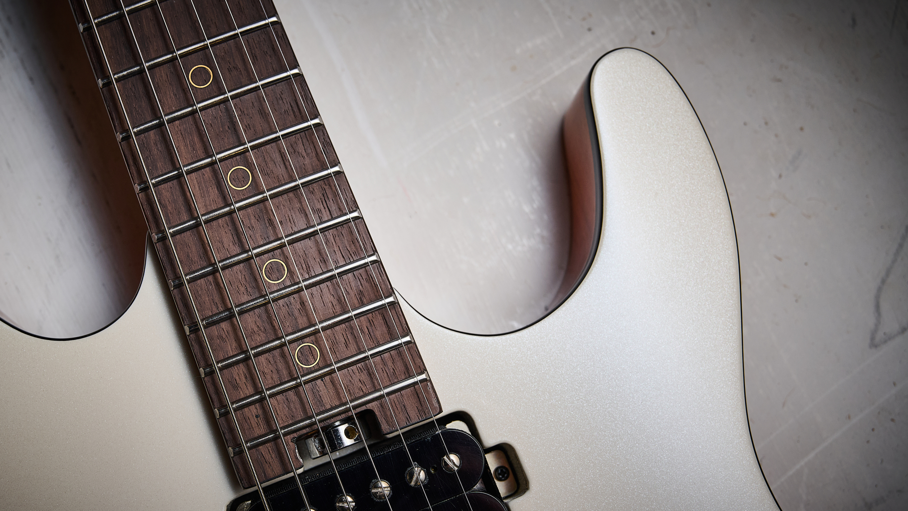 The rosewood fretboard and lower horn of the Harley Benton Fusion IV HH electric guitar