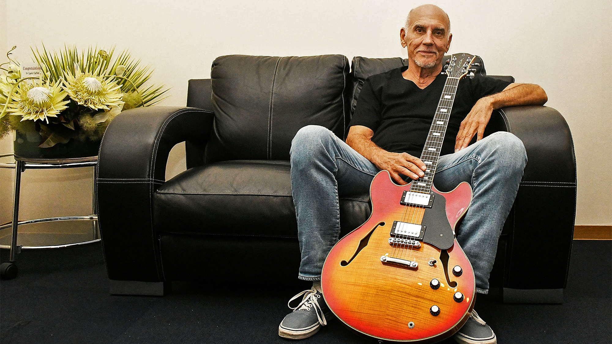 Larry Carlton poses holding his signature guitar 'Sire Larry Carlton H7' backstage during 'The Crusaders Remembered &amp; Greatest Hits Steely Dan' at Billboard Live on June 9, 2022 in Tokyo, Japan.