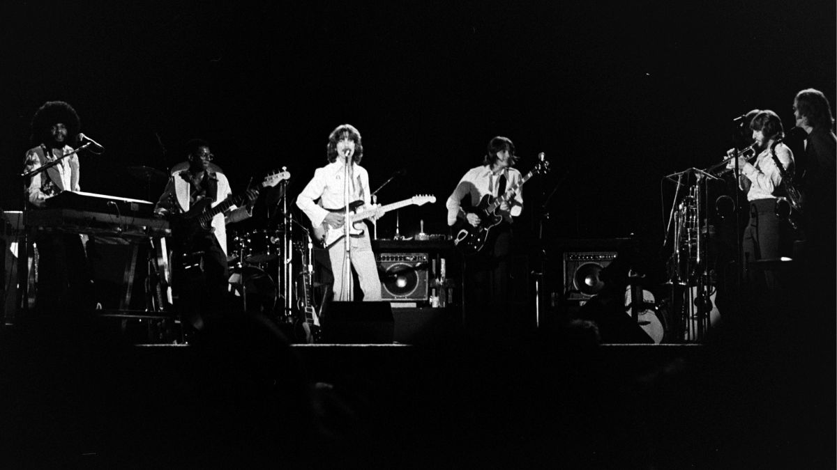 (L-R) Billy Preston, Willie Weeks, George Harrison, Robben Ford, Chuck Findley, and Tom Scott perform onstage at the Forum in Los Angeles in November 1974.