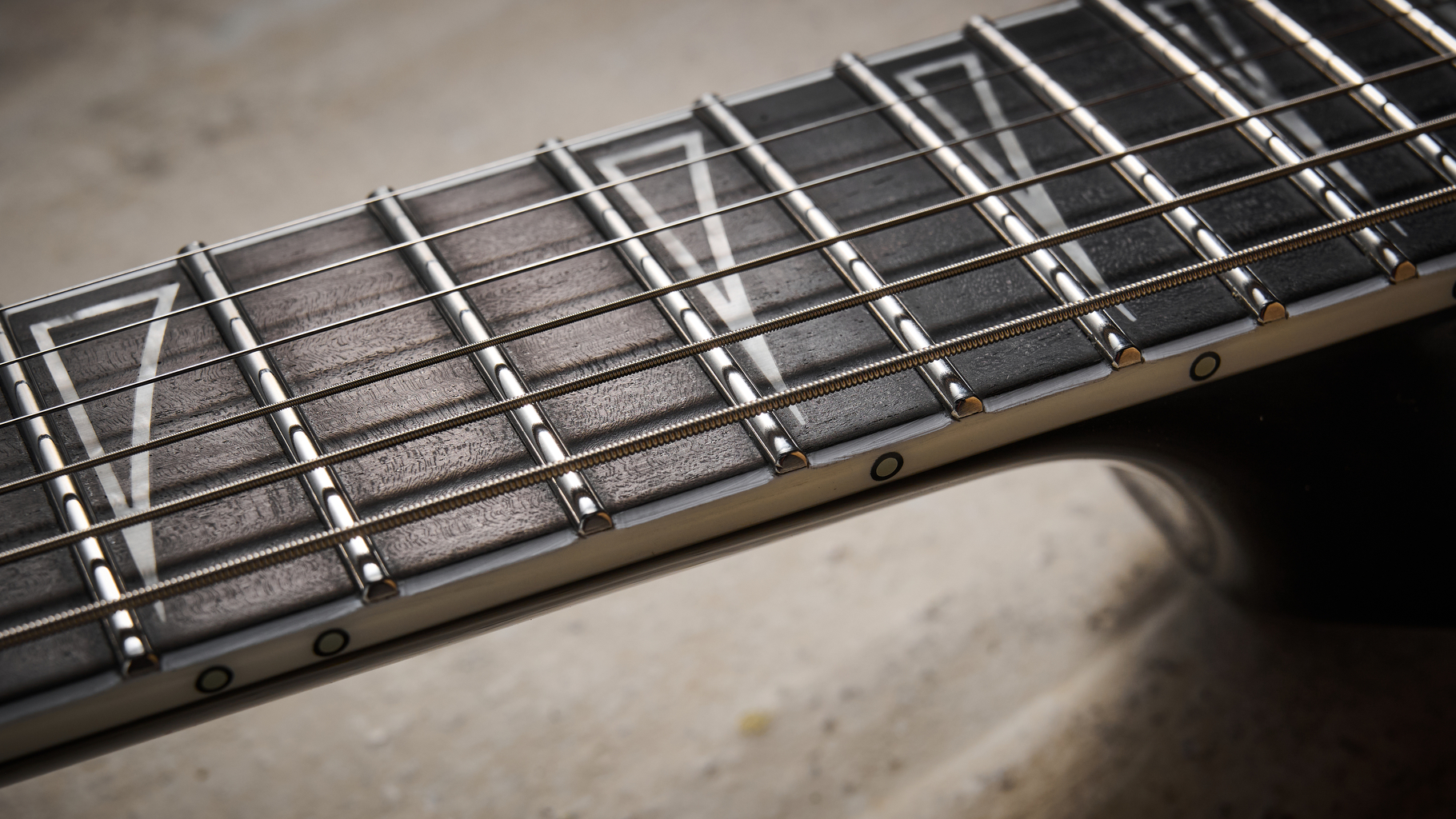Close up of the Luminlay side dots on the Jackson Pro Plus Series Signature Christian Andreu Rhoads RR24 EVTN6 electric guitar fretboard