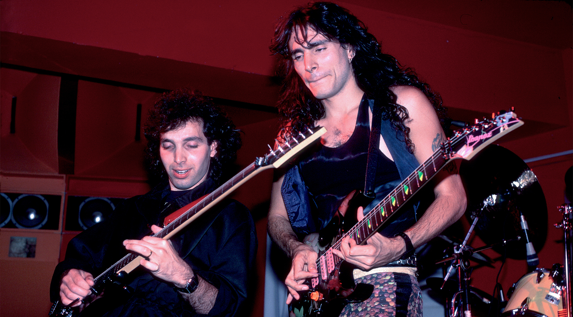 Joe Satriani (left) and Steve Vai play guitars as they perform onstage the Limelight, Chicago, Illinois, June 27, 1987.