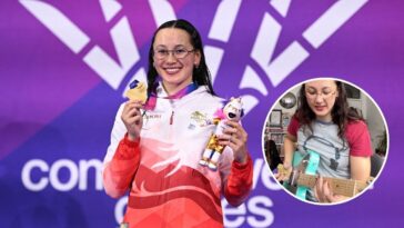 Swimmer uses gold medal as a guitar pick for a Megadeth riff